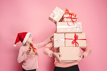 Image showing Portrait of a surprised little girl with her father holding a Christmas present