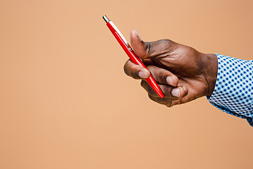 Image showing Male hand holding pencil, isolated