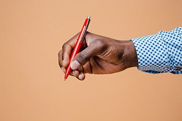 Image showing Male hand holding pencil, isolated