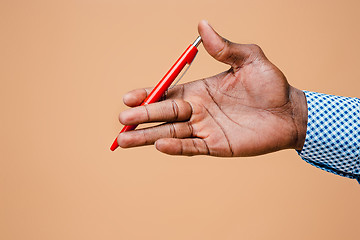 Image showing Male hand holding pencil, isolated