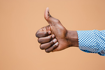 Image showing Hand showing OK sign isolated on brown background.