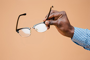 Image showing Male hand holding glasses, isolated