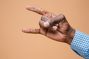 Image showing Male, man, hipster, in shirt, hand raised showing a heavy metal rock sign