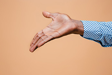 Image showing Handshake. Hands of businessman isolated on brown background