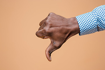 Image showing Thumb down hand sign on brown, seal of disapproval