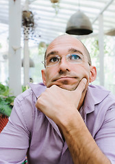 Image showing Attractive Pensive Bald Man Wearing Glasses