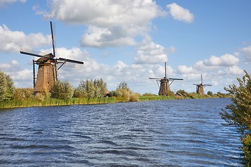 Image showing Windmill beside a canal