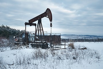 Image showing Oil well on a winter landscape