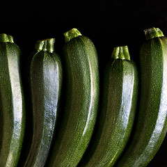 Image showing Zucchini (zucchetti, courgettes) on a black background