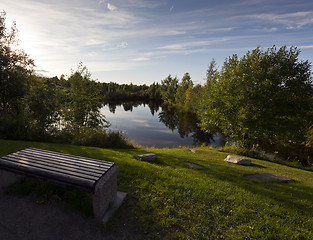 Image showing A bench by the water in evening. Finland