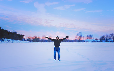 Image showing Inspired Traveller With His Arms Raised Enjoys The Romantic Suns