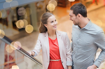 Image showing happy young couple with shopping bags in mall