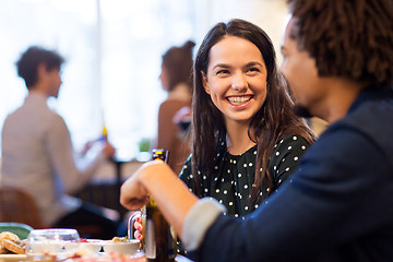 Image showing happy couple with drinks at restaurant or bar