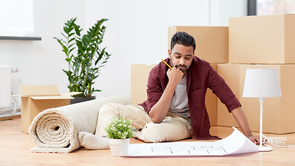 Image showing man with blueprint and boxes moving to new home