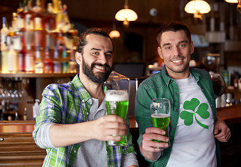 Image showing male friends drinking green beer at bar or pub