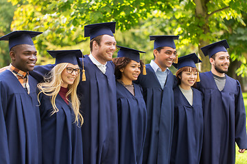 Image showing happy students or bachelors in mortar boards