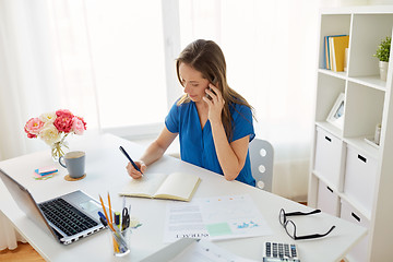 Image showing woman with notepad calling on smartphone at office