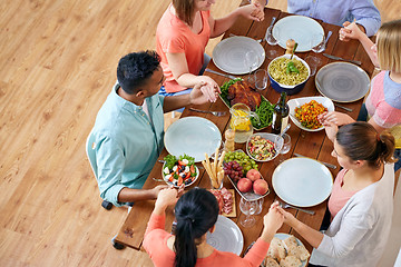 Image showing group of people at table praying before meal