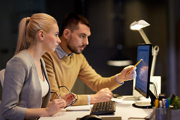 Image showing business team with computer working late at office