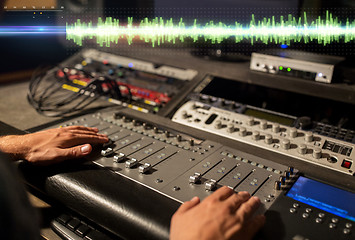 Image showing hands on mixing console at sound recording studio