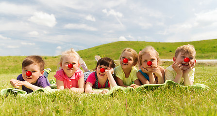 Image showing happy kids lying on meadow at red nose day