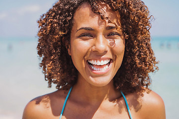 Image showing Laughing ethnic woman at the ocean