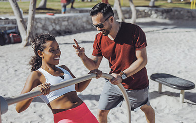 Image showing Man training woman on beach