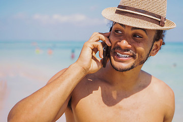 Image showing Cheerful man standing with smartphone