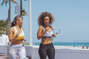 Image showing Content women jogging in tropical sunshine