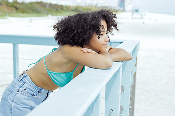 Image showing Pretty black girl enjoying view on beach