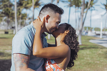 Image showing Amorous kissing couple in bright sunshine