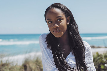 Image showing Attractive young black woman looking at camera in park