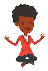 Image showing Business woman meditating in lotus position.