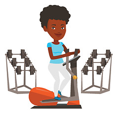 Image showing Woman exercising on elliptical trainer.