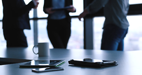 Image showing tablet, mobile cell phone and cup of coffee  in office with busi