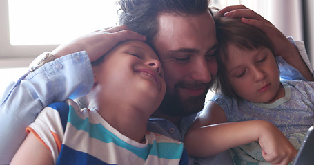 Image showing father and two kids having fun together at home