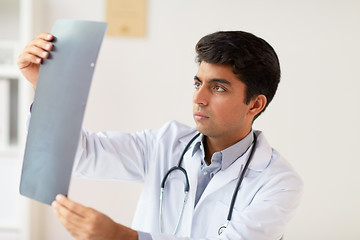 Image showing doctor looking at spine x-ray scan at clinic