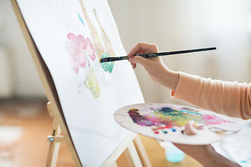 Image showing artist with palette painting at art studio