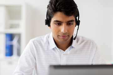 Image showing businessman with headset and laptop at office