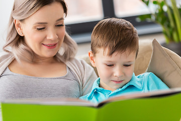 Image showing close up of happy mother and son reading book