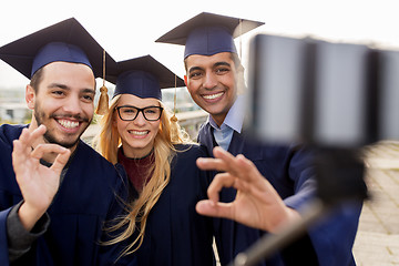 Image showing students or graduates taking selfie by smartphone