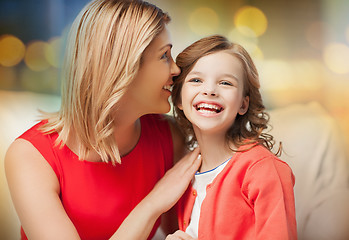 Image showing happy mother and girl whispering into ear