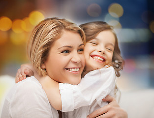 Image showing happy mother and little daughter hugging