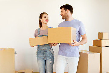 Image showing happy couple with boxes moving to new home