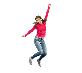 Image showing smiling young woman jumping in air