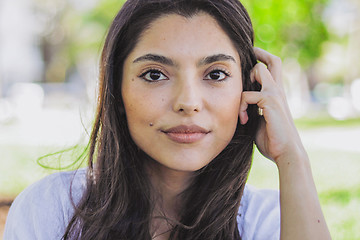 Image showing Attractive brunette in summertime looking at camera