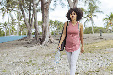 Image showing Relaxed girl with water and yoga mat