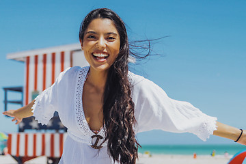 Image showing Cheerful ethnic woman laughing on beach