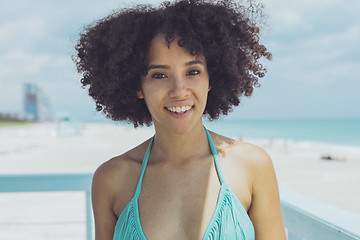 Image showing Cheerful black woman in sunlight on beach