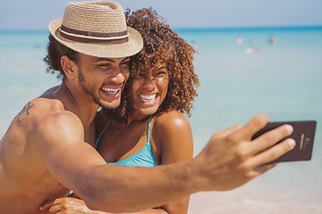 Image showing Cheerful happy couple selfies on beach